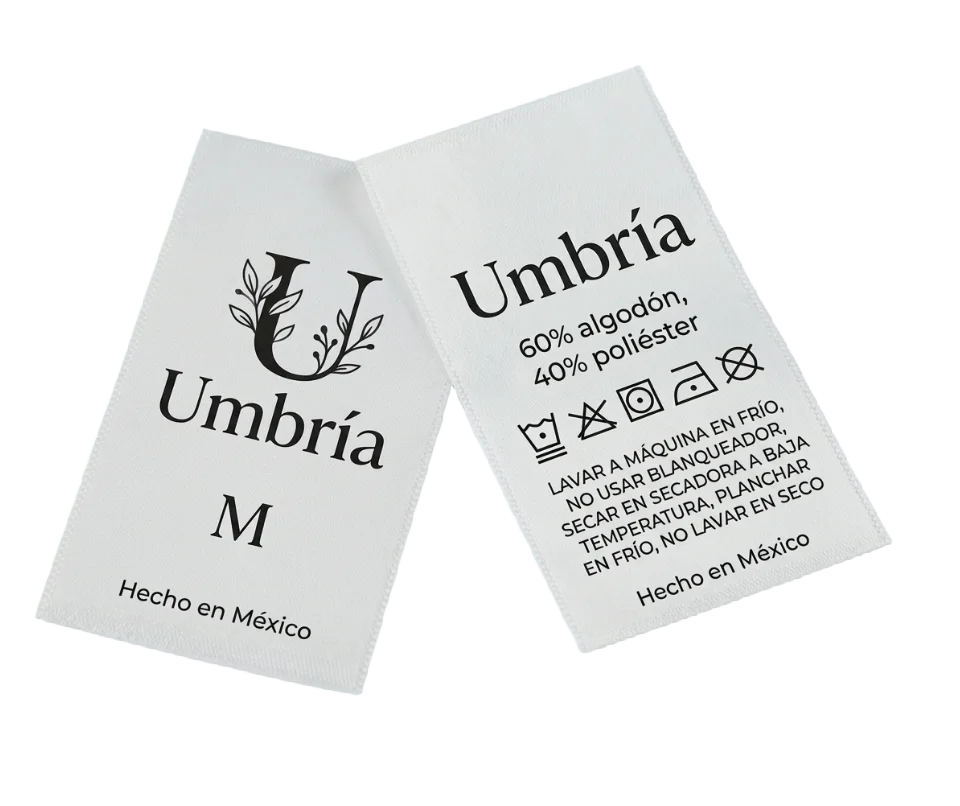 Etiqueta textil donde se muestra la marca Umbria y el tamaño así como indicaciones de cuidado para lavado y la composición del textil fabricado por Etimex Digital en Mexico.
